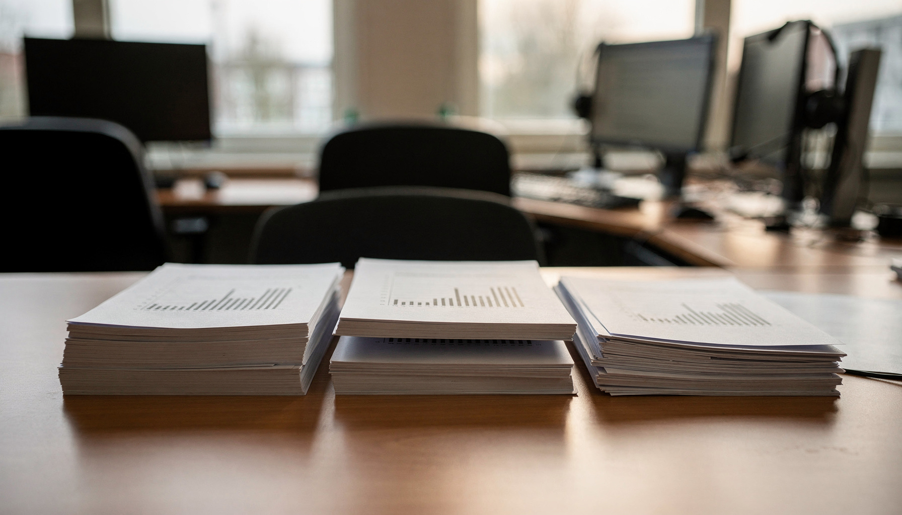 Drie stapels rapportages liggen naast elkaar, waarvan één stapel duidelijk incompleet is.